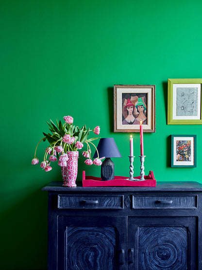 Salón con pared en Wall Paint Schinkel Green, aparador en Oxford Navy con detalles en Old White, bandeja en Capri Pink y marco Firle de Annie Sloan