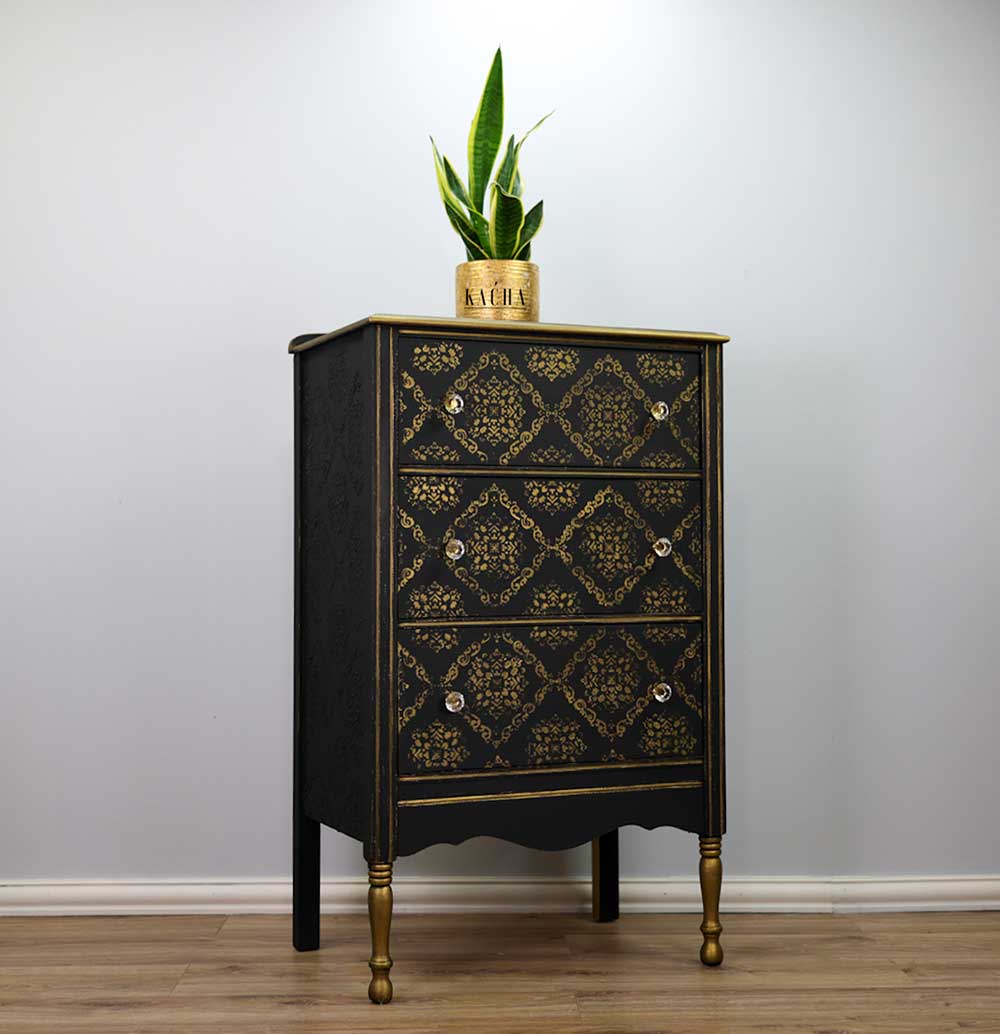 Stencil Modern Moroccan Kacha en cómoda alta negra con patas doradas restaurada - patrón geométrico marroquí dorado en cajones, tiradores de cristal - Re-Design with Prima - ambassador Kacha
